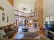 Open living room with a two-story high brick fireplace and hardwood floors at 2395 Windward Cv, Kissimmee, FL 34746