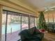Living room with Christmas tree and view of the pool at 2395 Windward Cv, Kissimmee, FL 34746