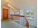 Bright loft with wood railing and large window at 2395 Windward Cv, Kissimmee, FL 34746