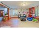 Bright playroom with hardwood floors, toys, and built-in shelving at 2395 Windward Cv, Kissimmee, FL 34746