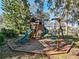 Wooden playset with slide and swings in a shaded backyard at 2395 Windward Cv, Kissimmee, FL 34746