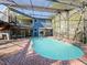 Large kidney-shaped pool with screened enclosure and deck at 2395 Windward Cv, Kissimmee, FL 34746