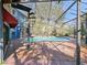 Inviting kidney-shaped pool with screened enclosure and brick deck at 2395 Windward Cv, Kissimmee, FL 34746