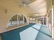 Large screened porch with arched windows and ceiling fan at 2395 Windward Cv, Kissimmee, FL 34746