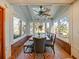 Bright sunroom with water views, dining table, and brick flooring at 2395 Windward Cv, Kissimmee, FL 34746