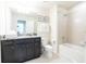 Bathroom boasts granite countertop, dark wood cabinets, and bathtub at 2472 Dubai St, Kissimmee, FL 34747