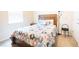 Cozy bedroom with wood bed frame and patterned bedding at 2472 Dubai St, Kissimmee, FL 34747