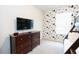Bedroom with a dresser, TV, and Mickey Mouse-themed wallpaper at 2472 Dubai St, Kissimmee, FL 34747