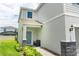 Side entrance with blue door, stone accents, and a small bench at 2472 Dubai St, Kissimmee, FL 34747