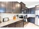 Kitchen with granite countertops and dark brown cabinets at 2472 Dubai St, Kissimmee, FL 34747