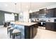 Modern kitchen with granite countertops, dark cabinetry, and stainless steel appliances at 2472 Dubai St, Kissimmee, FL 34747