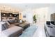 Spacious living room with L-shaped sectional sofa, coffee table, and large TV at 2472 Dubai St, Kissimmee, FL 34747