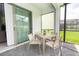Screened patio with seating area and access to backyard at 2472 Dubai St, Kissimmee, FL 34747