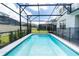 Enclosed rectangular pool with safety fence at 2472 Dubai St, Kissimmee, FL 34747