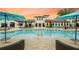 Community pool and clubhouse with lounge areas at 2472 Dubai St, Kissimmee, FL 34747