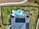 Bird's-eye view of a house with a solar-paneled roof and a refreshing pool at 2583 Grassmoor Loop, Apopka, FL 32712