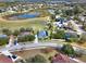 Aerial view of the house and neighborhood with a lake in the background at 2583 Grassmoor Loop, Apopka, FL 32712