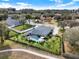 Aerial view of a house with a pool, showcasing its backyard and neighborhood at 2583 Grassmoor Loop, Apopka, FL 32712