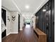 Long entryway with dark wood bench and walls at 2583 Grassmoor Loop, Apopka, FL 32712