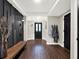 Bright entryway with dark wood bench and walls at 2583 Grassmoor Loop, Apopka, FL 32712
