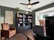 Home office with built-in shelving and comfortable seating at 2583 Grassmoor Loop, Apopka, FL 32712