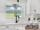 Kitchen sink with black faucet and white cabinets at 2583 Grassmoor Loop, Apopka, FL 32712