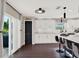 Modern kitchen with white cabinets, island, and sliding door to patio at 2583 Grassmoor Loop, Apopka, FL 32712