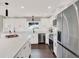 Modern kitchen with stainless steel appliances and white cabinets at 2583 Grassmoor Loop, Apopka, FL 32712