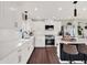 White kitchen with stainless steel appliances and island at 2583 Grassmoor Loop, Apopka, FL 32712