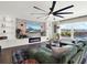 Living area featuring a built-in entertainment center and a large TV at 2583 Grassmoor Loop, Apopka, FL 32712