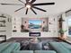 Living room with built-in shelving and a stone fireplace at 2583 Grassmoor Loop, Apopka, FL 32712