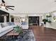 Spacious living room featuring a large sectional sofa and dark hardwood floors at 2583 Grassmoor Loop, Apopka, FL 32712