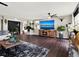 Open living space with a large TV, fireplace, and ample natural light at 2583 Grassmoor Loop, Apopka, FL 32712