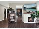 Living room with a modern fireplace, large TV, and plenty of natural light at 2583 Grassmoor Loop, Apopka, FL 32712