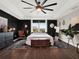 Spacious main bedroom with dark walls, ceiling fan, and a view of the backyard at 2583 Grassmoor Loop, Apopka, FL 32712