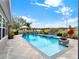 Inviting pool area with spa and fire pit at 2583 Grassmoor Loop, Apopka, FL 32712