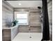 Clean and modern walk-in shower with gray tile and a rain shower head at 2583 Grassmoor Loop, Apopka, FL 32712