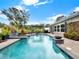Inviting swimming pool with a spacious patio and lush landscaping at 2583 Grassmoor Loop, Apopka, FL 32712