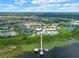 Aerial view of community with lake, tennis courts, and clubhouse at 2777 Southland St, St Cloud, FL 34772