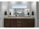 Double vanity bathroom with granite countertops and dark brown cabinets at 2777 Southland St, St Cloud, FL 34772