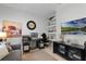 Home office with built-in shelving, desk, and comfortable seating at 2777 Southland St, St Cloud, FL 34772