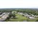 Aerial view of the neighborhood featuring golf course and wooded areas at 32512 Oak Park Dr, Leesburg, FL 34748