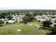 A golf course and residential area offer community living, with mature trees and well-maintained lawns at 32512 Oak Park Dr, Leesburg, FL 34748
