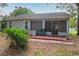 Cozy back patio with a small sink, screened windows, and ample outdoor space at 32512 Oak Park Dr, Leesburg, FL 34748