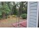 View of the backyard that includes a red brick patio and a lot of trees at 32512 Oak Park Dr, Leesburg, FL 34748