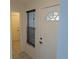 Inviting entryway with half-moon window in door and tile flooring, creating a welcoming atmosphere at 32512 Oak Park Dr, Leesburg, FL 34748