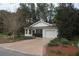 Home exterior with a manicured lawn, mulch beds, and an attached one car garage at 32512 Oak Park Dr, Leesburg, FL 34748