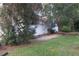 Exterior view of the house with green lawn, offering privacy and a beautiful setting at 32512 Oak Park Dr, Leesburg, FL 34748