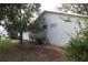 Exterior view of the house with trees, providing shade and curb appeal at 32512 Oak Park Dr, Leesburg, FL 34748