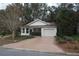 Charming single-story home with an attached garage, well-maintained lawn, and mature landscaping at 32512 Oak Park Dr, Leesburg, FL 34748